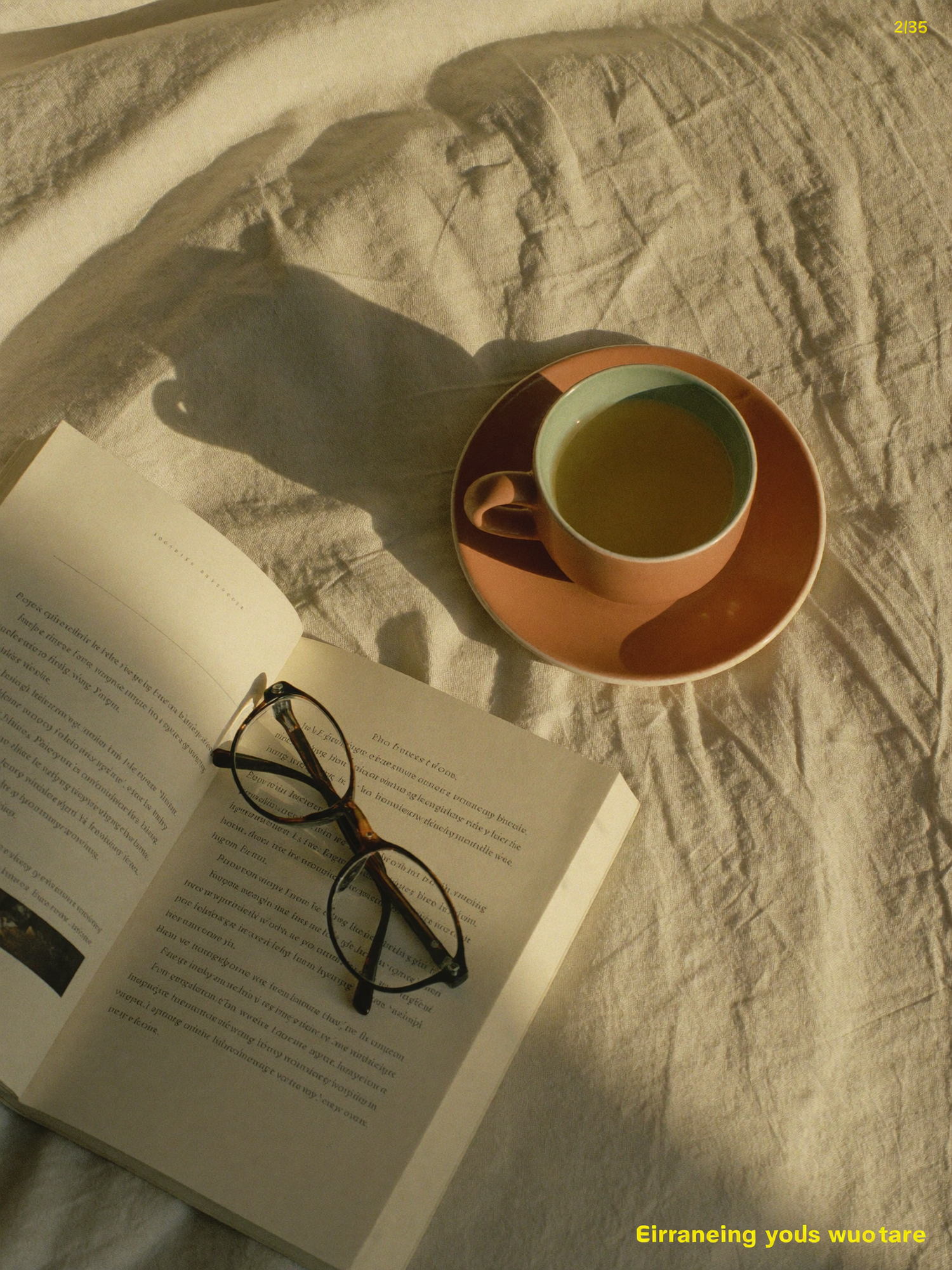 A half-finished cup of tea on rumpled linen in warm morning light